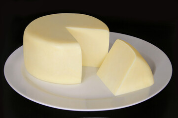 MINAS STANDARD CHEESE SLICED ON ISOLATED BLACK BACKGROUND