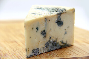 GORGONZOLA CHEESE ON ISOLATED WOODEN BACKGROUND
