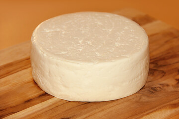 WHOLE FRESCAL MINAS CHEESE ON WOODEN BOARD WITH ISOLATED BACKGROUND - TRADITIONAL CHEESE FROM MINAS GERAIS