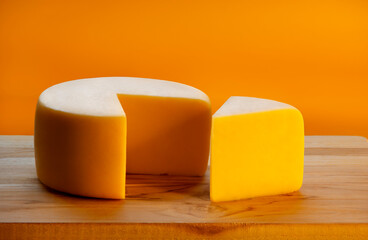 MINAS HALF-CURED CHEESE ON A WOODEN BOARD IN AN ISOLATED BACKGROUND
