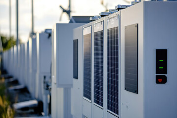 Rows of advanced battery storage systems integrated with solar panels