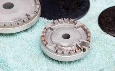 A black and silver object with a hole in the middle sits on a green cloth