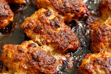 A pan of meat is cooked and has a crispy crust