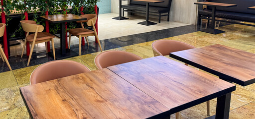 A restaurant with wooden tables and chairs