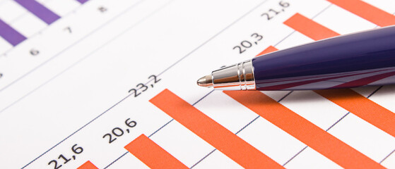 Pen and financial chart showing production or sales statistics. Business