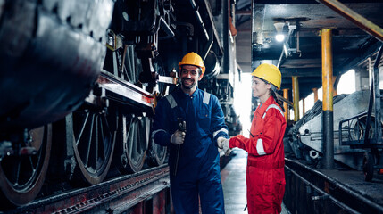 Team of engineer railway wearing safety uniform and helmet under checking under train ,wheels and control system for safety travel passenger. Maintenance cycle concept.
