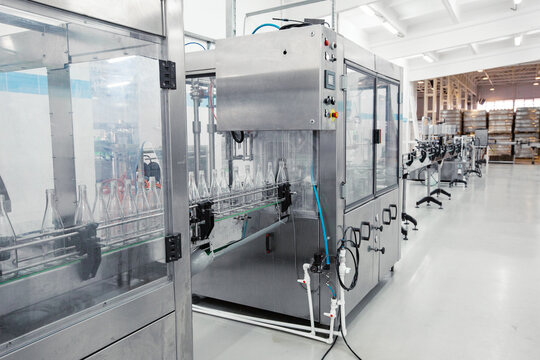 Advanced bottling machine operates in a modern beverage manufacturing facility during daylight hours
