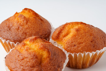 Freshly baked muffins arranged on a white surface ready for serving during a morning gathering