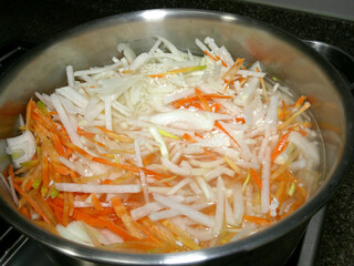 Cook healthy rice with vegetables. Rice with carrots, radishes and onions.
