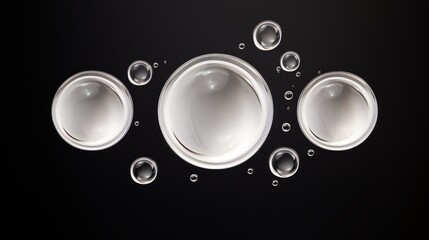 Abstract image of three large white spheres surrounded by smaller bubbles on a black background.