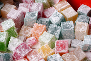 Colorful Turkish delight squares displayed together in a vibrant arrangement at a market stall