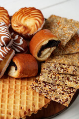 Assortment of sweet pastries and crispy snacks arranged on a wooden platter