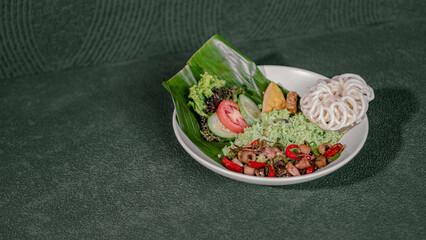 Fried Rice With Stir-Fried Squid, Tofu, Tempe, Vegetable Salad, And Crackers, Served On A White Plate, A Savory And Spicy Dish.