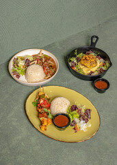 BBQ Beef with Sauce, Rice, and Salad on a Plate, Beef Steak with Mozzarella Cheese and Salad in a Skillet, Beef Slices with Mushroom Sauce, Rice, and Salad in a Bowl.
