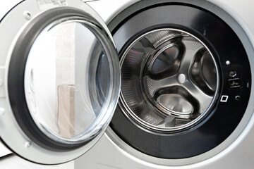 Washing machine with open door showcasing interior drum and control panel features for laundry tasks