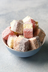 Colorful coconut treats arranged in a bowl, perfect for festive gatherings and celebrations
