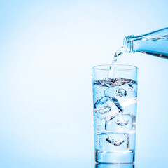 Crystal clear water being poured into a transparent glass, creating refreshing ripples and bubbles