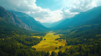 Obraz premium Breathtaking aerial view of green valley surrounded by majestic mountains