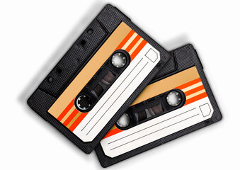 Retro Cassette Tapes: Two vintage audio cassette tapes with a retro orange and white design lie...