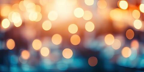 Obraz premium Warm golden bokeh lights create a blurred background, with soft transitions of orange and blue hues, perfect for festive or celebratory themes.
