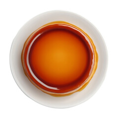 A top view shows a delicious caramel flan dessert on a white plate the flan is smooth and glossy with a rich caramel topping.