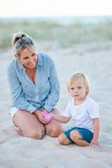 Mother and son playing together on the sand on Gold Coast beach