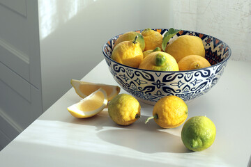 Wild yellow-green unripe lemons in plate. Environmentally friendly product. Eco-friendly pure natural product. 