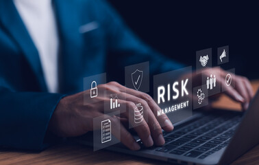 Fototapeta premium Risk management strategy concept. A businessman use laptop analyzing, a risk management interface with critical strategy. Risky business risk management control and strategy. Stability unforeseen.