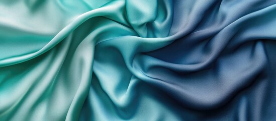 Fototapeta premium Elegant blue and green satin and silk texture creating an ombre effect with smooth folds perfect for upscale wallpaper and interior design projects.