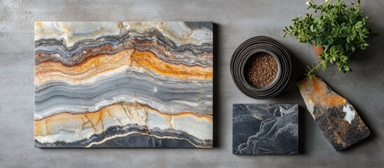 Elegant abstract slab stone designs featuring a large slab with orange and grey tones, a small slab, a pot with plants, set against a stylish grey background.