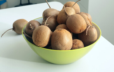 Group of kiwi with tails from home garden in bowl. Eco-friendly pure natural product. 