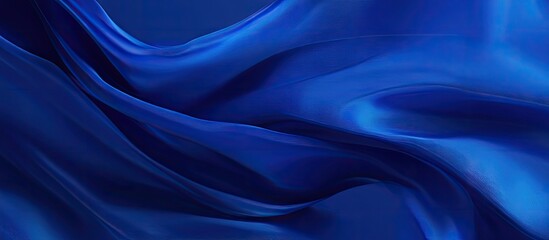 Obraz premium Elegant deep blue silk fabric flowing gracefully, creating a soft wave effect. Ideal for themes of celebration and elegance in design projects.