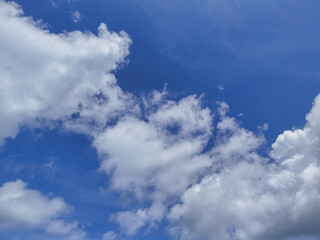White clouds and blue sky from below