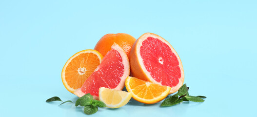 Many different citrus fruits on light blue background