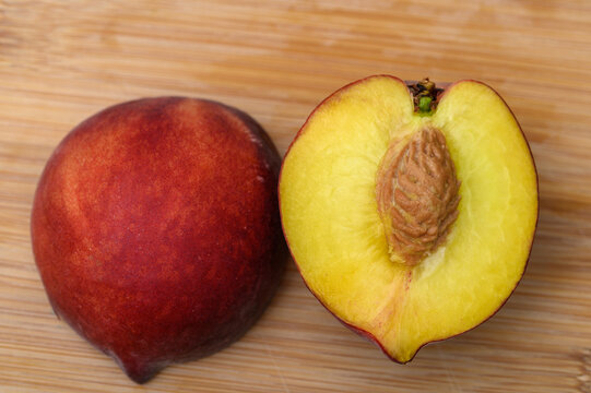 Close-up of a cross-section of a halved peach, a ripe dessert fruit - Powered by Adobe