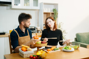 Couple cooking at home. young couple cooking together with Bread and fruit fresh vegetables, embracing healthy eating
