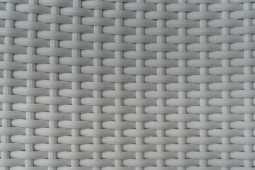Woven textured white faux leather material, plastic weave as woven background texture or pattern