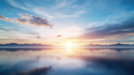 Fototapeta premium Serene Sunrise Over Calm Waters and Mountainscape