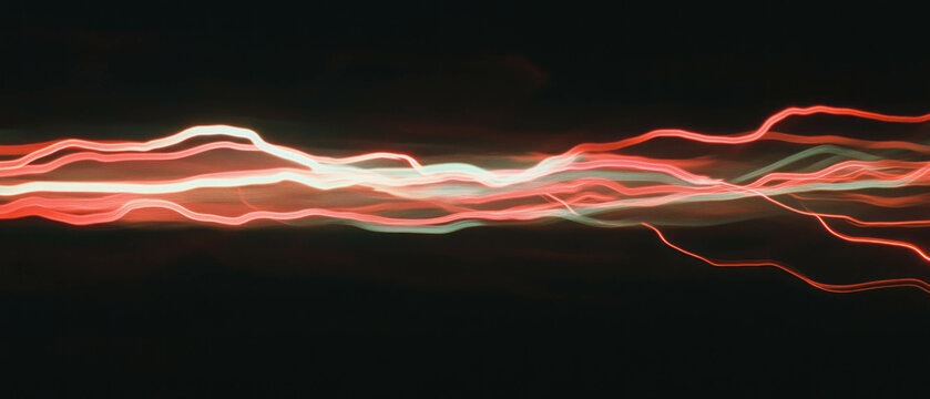 Dynamic display of red hot wires with vibrant light trails illustrating velocity and danger