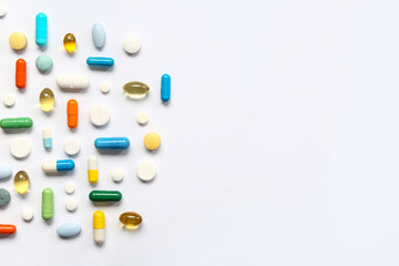 Fish oil capsules and different pills on white background