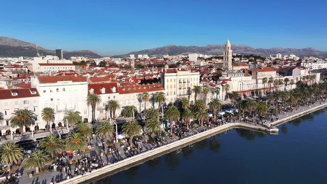 A spectacular view from the sea of the Split Riva on New Year&rsquo;s Eve, with crowds celebrating and the iconic Saint Domnius Cathedral towering over the historic cityscape.