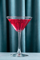 Red cocktail on blue velvet background