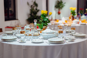 Elegant vintage dining table with porcelain and glassware in a retro style, exuding warmth and tradition