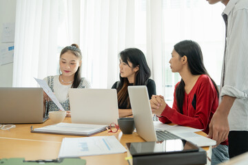 Group of Asian office worker working together with round table in office room