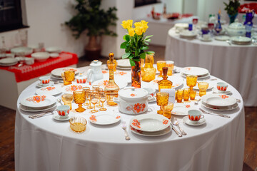 Elegant vintage dining table with porcelain and glassware in a retro style, exuding warmth and tradition
