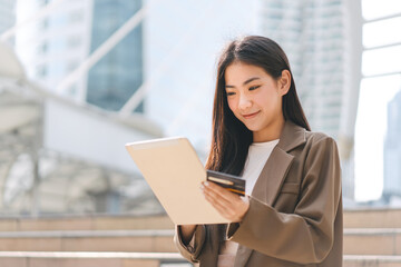 Fototapeta premium Happy smile young woman using credit card and digital tablet for shopping online payment