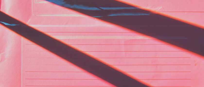 Creative workspace with pink lined paper and decorative feminine details for organizing thoughts