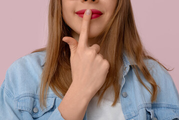 Fototapeta premium Young deaf mute woman using sign language on pink background, closeup
