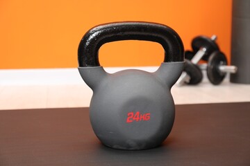 One kettlebell on mat indoors, closeup. Sport equipment