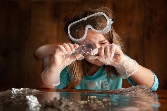 Up close young girl science experiment at home - Powered by Adobe